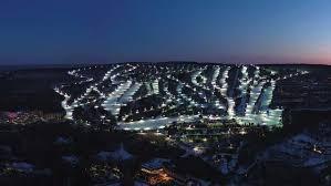 A breathtaking night view of Camelback Resort in the Poconos, showcasing illuminated ski slopes and tubing lanes at the Camelback snow park. This iconic PA ski destination offers the perfect blend of skiing and winter tubing adventures, making it one of the best Poconos ski resorts for family winter getaways.