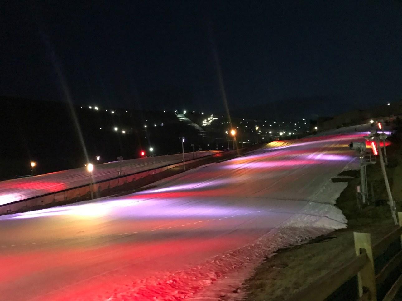 Nighttime snow tubing at Camelback Resort in the Poconos, featuring brightly lit lanes and colorful LED lights that create a magical winter adventure. Perfect for family fun and thrilling winter activities at one of the best Poconos ski destinations.