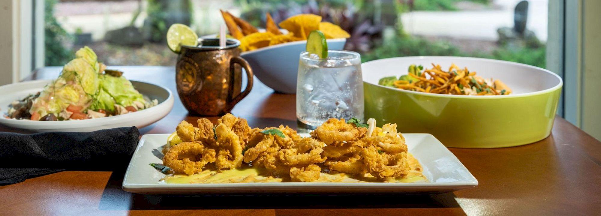 What sets Saddlebrook restaurants apart from the competition — a display of uncompromising quality across all venues featuring crispy fried calamari, fresh salads, signature cocktails, and gourmet resort dining presentation.