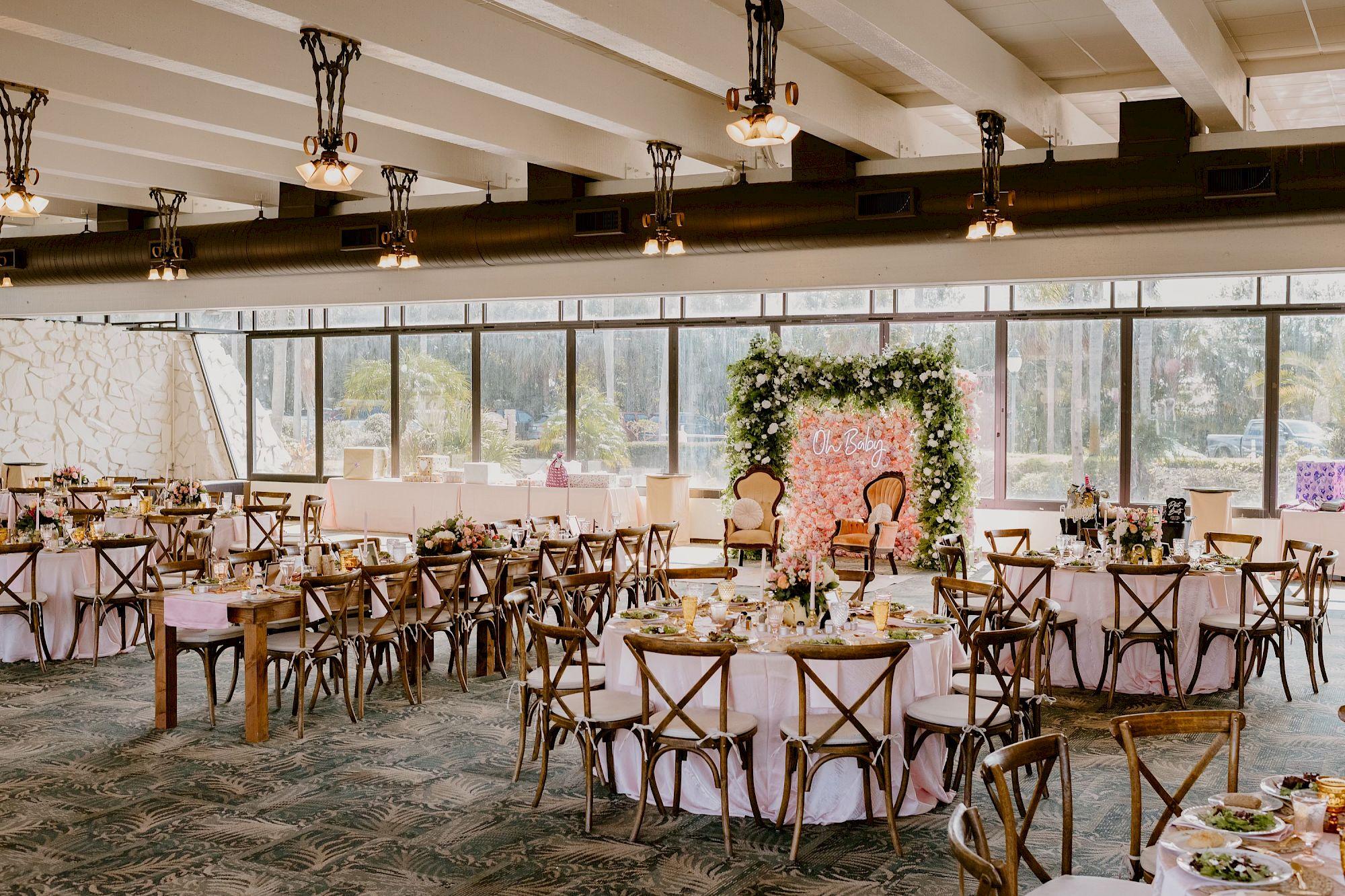 Customized catering for special events at Saddlebrook Resort featuring beautifully arranged round and banquet tables, elegant floral décor, and a scenic indoor event space perfect for celebrations.