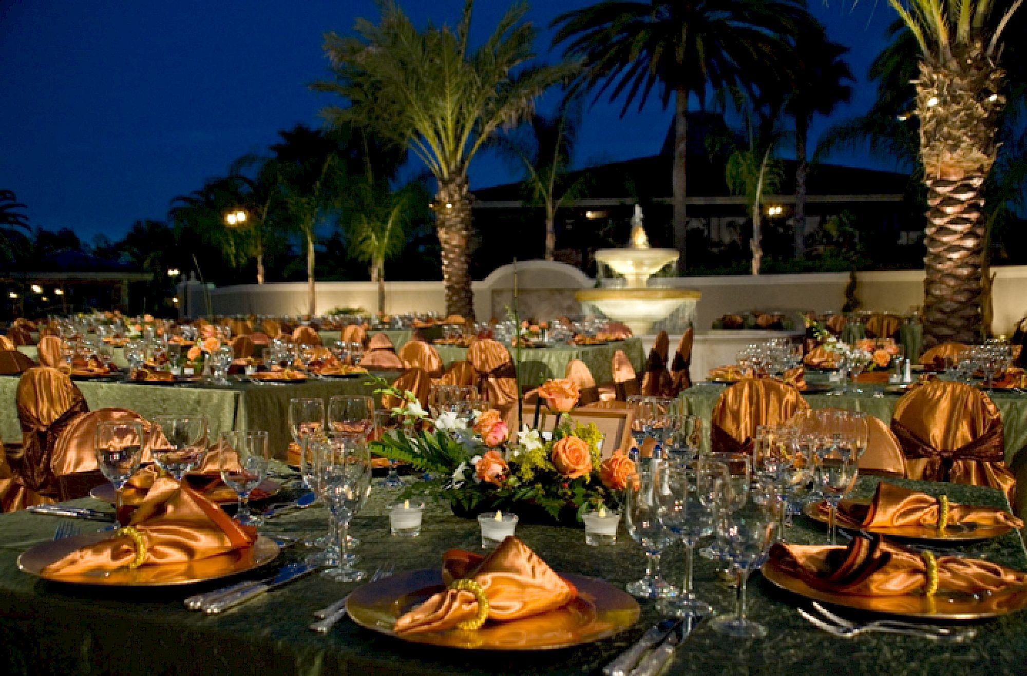 Elegant outdoor dining setup at Saddlebrook Resort showcasing comprehensive culinary programs beyond standard dining, featuring fine table settings and a tropical evening ambiance.