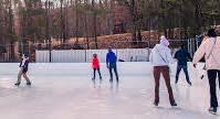 Guests enjoy outdoor ice skating surrounded by trees at Massanutten Resort’s scenic ice rink in Virginia’s Blue Ridge Mountains.