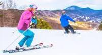 Families enjoy skiing and snowboarding together on the snowy slopes of Virginia's Blue Ridge Mountains, showcasing fun-filled winter adventures perfect for all ages.